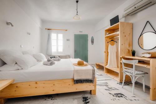a bedroom with a wooden bed and a desk at Naxos Aethereal View in Kastraki