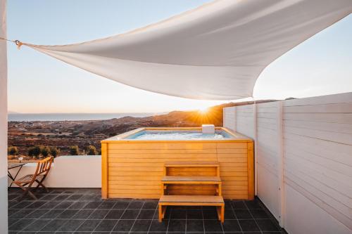 a hot tub on the balcony of a house at Naxos Aethereal View in Kastraki