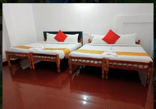 two beds sitting next to each other in a room at Nature Quite in Vattavada