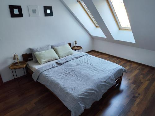 a bedroom with a large bed in a attic at Rooftop Apartment in Šamorín