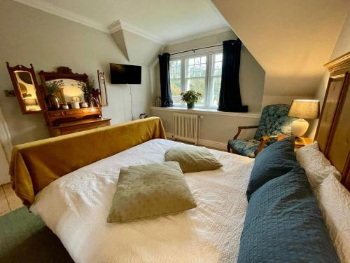 a bedroom with a bed with two pillows on it at Room 3, Wedale House in Stow
