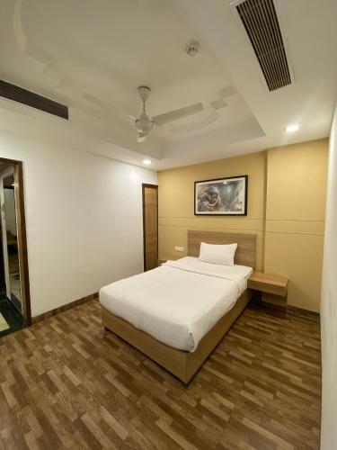 a bedroom with a large white bed in a room at Hotel KC Cross Road Panchkula in Panchkula
