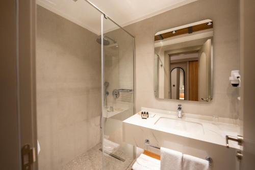 a bathroom with a sink and a shower at Reiwa Business Hotel in Osmaniye