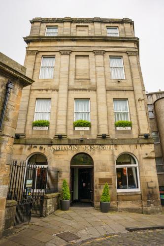 a large stone building with a sign on it at The Parliament House Hotel in Edinburgh