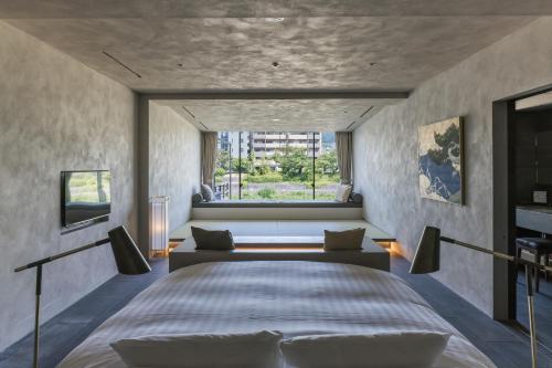 a bedroom with a large bed and a couch at Shizuru 鴨川 ""旧SGR鴨川"" in Kyoto