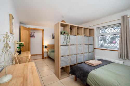 a small bedroom with a bed and a window at Shannon View Jungle House in Athlone