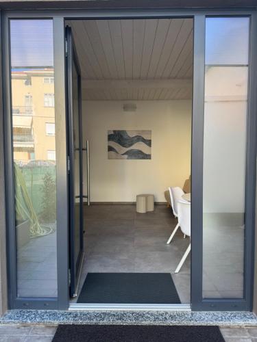 an open glass door leading to a living room at Dimora degli Ulivi in Rimini