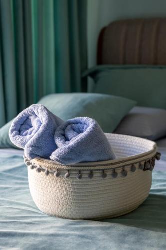 a bowl with a purple towel sitting on a bed at Centre Budva Blue in Budva