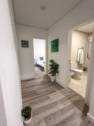 a hallway of a bathroom with a toilet and a sink at Casa Rosa in Parede