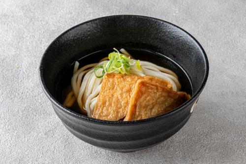a black bowl of soup with a sandwich and noodles at Hotel Flower Style koriyama tenri in Tenri