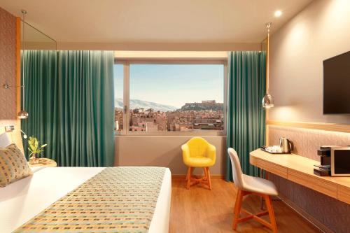 a hotel room with a bed and a window at Zeus Wyndham Grand Athens in Athens