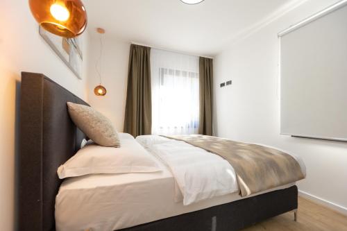 a bedroom with a large bed with a large window at Villa Mauro in Božava