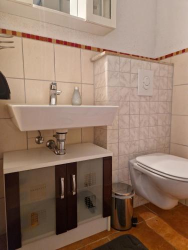 a bathroom with a sink and a toilet at Lange Str. 15 - Ferienwohnung in Prerow
