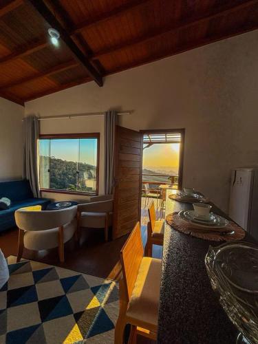 a living room with a couch and a table at Chalés Mirante da Colina in Venda Nova do Imigrante