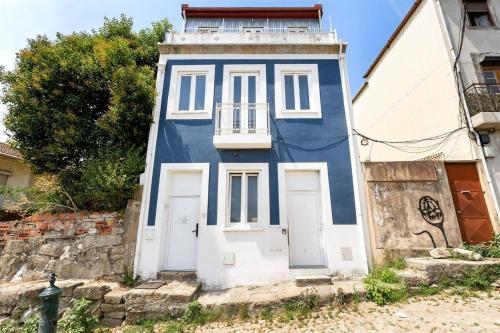 a blue and white building with a balcony at PortoNest Downtown Suites in Porto