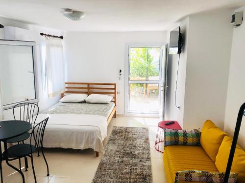 a bedroom with a bed and a couch and a table at Small House in Bodrum in Milas