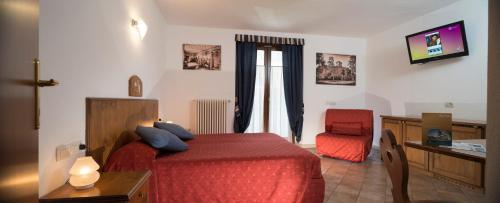 a bedroom with a red bed and a red chair at Hotel Residence Chateau in Saint-Pierre