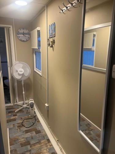 a walk in shower in a room with a mirror at The Snug - All Seasons Chalet Breaks in Leysdown-on-Sea