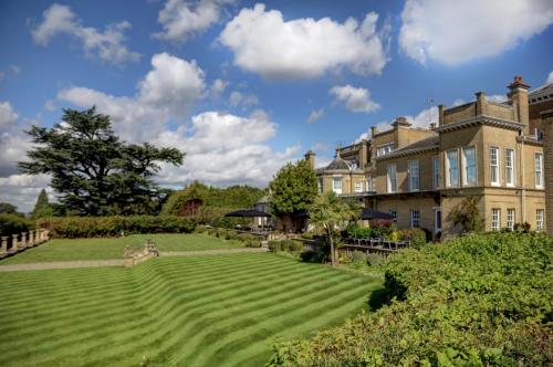 a large house with a large lawn in front at Best Western Chilworth Manor Hotel in Southampton