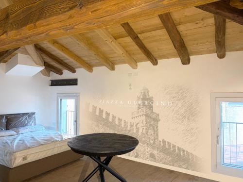 a bedroom with a bed and a table on a wall at Ugo Bassi 98 in Cento