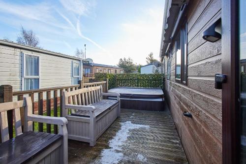a porch with two benches on a house at Host & Stay - 10th Avenue in Morpeth