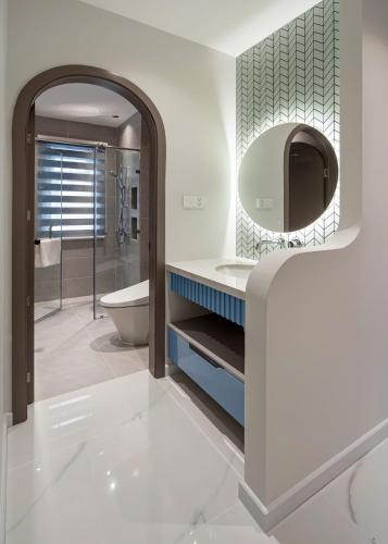 a bathroom with a sink and a mirror at Suri Villa in Bình Tú