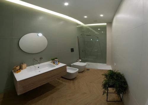 a bathroom with a sink and a toilet and a mirror at Palazzo Ducale in Salerno