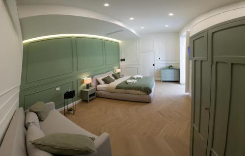 a bedroom with a couch and a bed in a room at Palazzo Ducale in Salerno