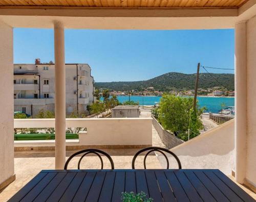 a view from the balcony of a house with a table and chairs at Holiday Home Vala in Vinišće
