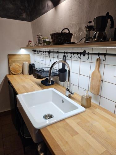 a kitchen with a white sink and a counter at Füstös Cottage Gömörszőlős in Gömörszőlős