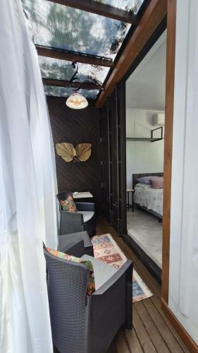 a room with a table and chairs and a bedroom at Pousada Encantos do Estaleiro in Balneário Camboriú