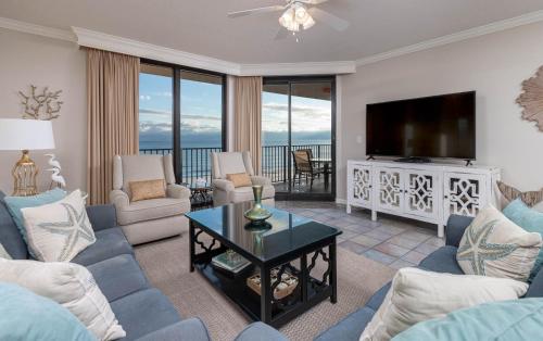 a living room with a couch and a tv at Phoenix X 609 condo in Orange Beach