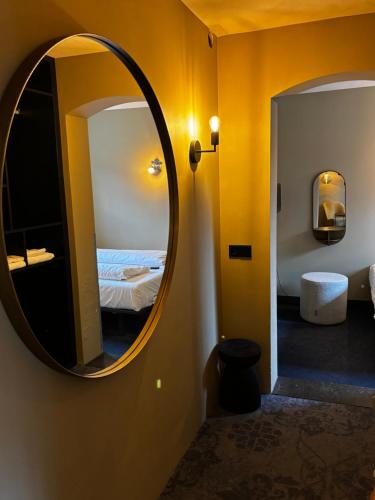 a mirror on a wall in a room with a bed at Hotel Oostereiland in Hoorn