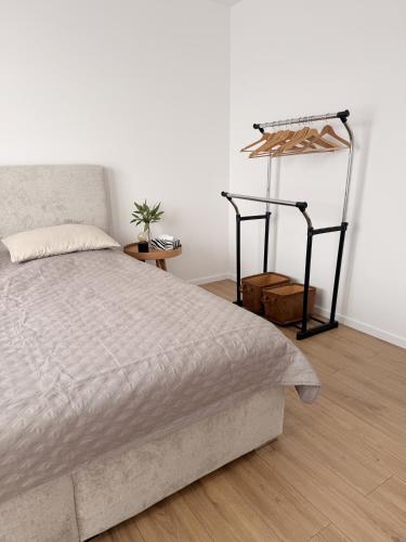 a bedroom with a bed and a white wall at apartman Sole in Trnava