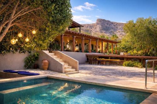 a house with a swimming pool in front of a house at Palazzo Navarone in Lindos
