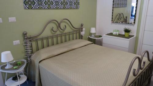 a bedroom with a large bed and two tables at Casa Verde Lerici in Lerici