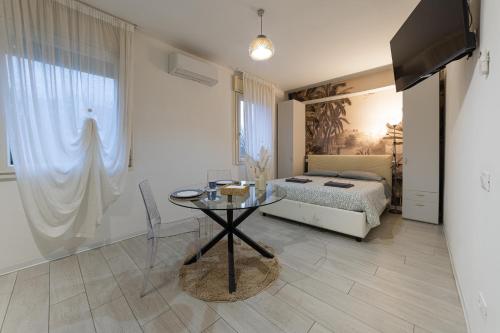 a bedroom with a table and a bed and a television at Casetta in Via Dini in Padova