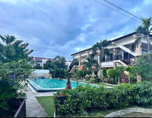 a swimming pool in front of a building at Townhouse in Agus
