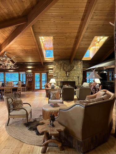 a living room with a large couch and a fireplace at Skyline Ranch in High Rolls
