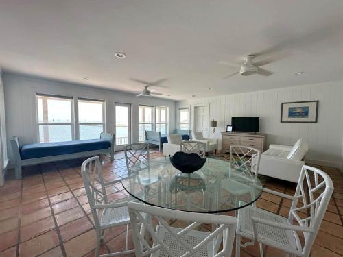 a living room with a glass table and chairs at Blue Heron Hideaway in Rockport