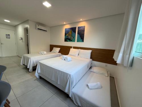 a room with two beds in a room at Porto Vila by AFT in Porto De Galinhas