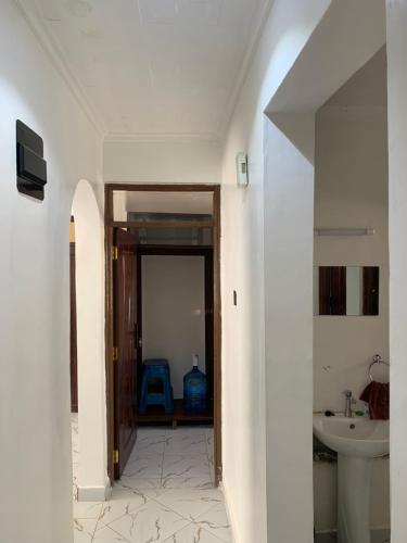 a hallway leading to a bathroom with a sink at Kisumu gateway 2br in Kisumu