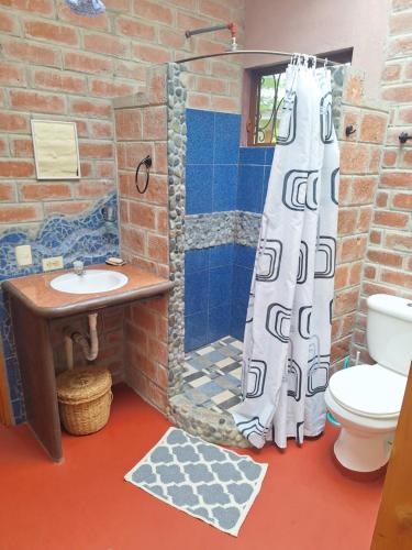 a bathroom with a shower and a sink at Casa Solomaco in Vilcabamba