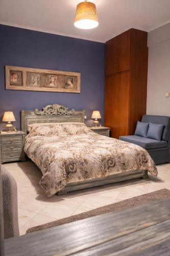 a bedroom with a bed and a blue wall at Art Suites Mesologgi in Missolonghi