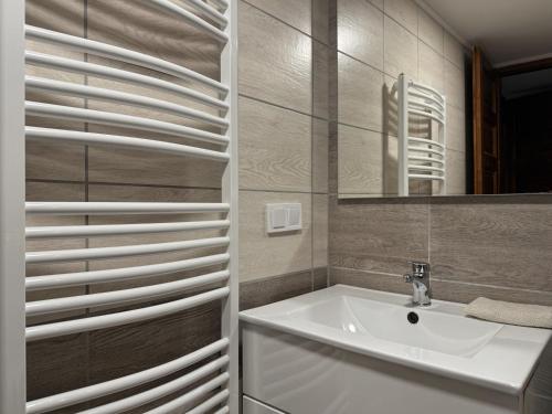 a bathroom with a sink and a mirror at Centrum Rezidencia Pápa in Pápa