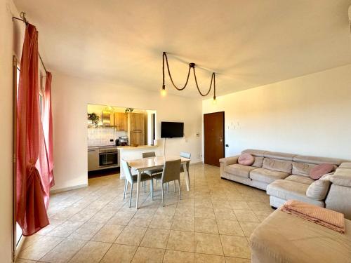 a living room with a couch and a table at Skyline Terrace in Loceri