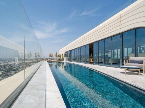 a swimming pool on the roof of a building at 21st Floor Sunset Apartment - Mercury Tower with Pool Access by Stays Uniq in St. Julianʼs