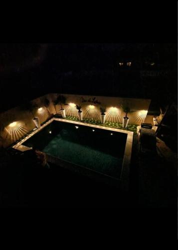 a night view of a swimming pool with lights at Fewo Saric Vir in Vir
