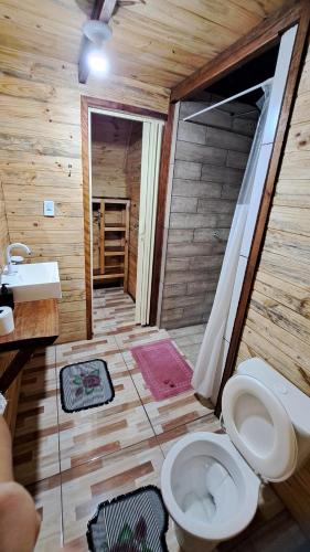 a bathroom with a toilet and a sink at Chalé da Ilha in Guaraqueçaba