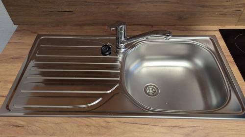 a stainless steel sink with a faucet on a counter at Pension Sonne in Baden-Baden